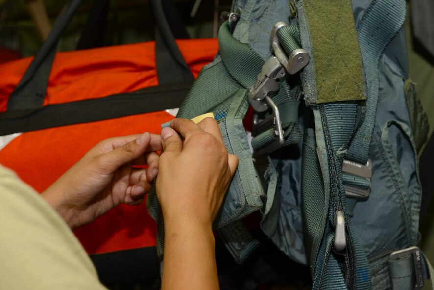 Master Sgt. Marittza Stewart, 86th Operations Support Squadron aircrew flight equipment technician, inspects a harness on a C-130J Super Hercules Aug. 16, 2015, at Otopeni Air Base, Romania. Approximately 80 personnel traveled to Otopeni Air Base to participate in Carpathian Summer, a bilateral training exercise designed to increase readiness and interoperability between the U.S. and Romanian air forces. The U.S. Air Force transferred authority to NATO of the three C-130J Super Hercules aircraft participating in the exercise. This Transfer of Authority is a standard procedure that will serve to enhance interoperability and readiness to conduct combined air operations with Romania and NATO. The TOA will end at the conclusion of the exercise. (U.S. Air Force photo/Senior Airman Timothy Moore)