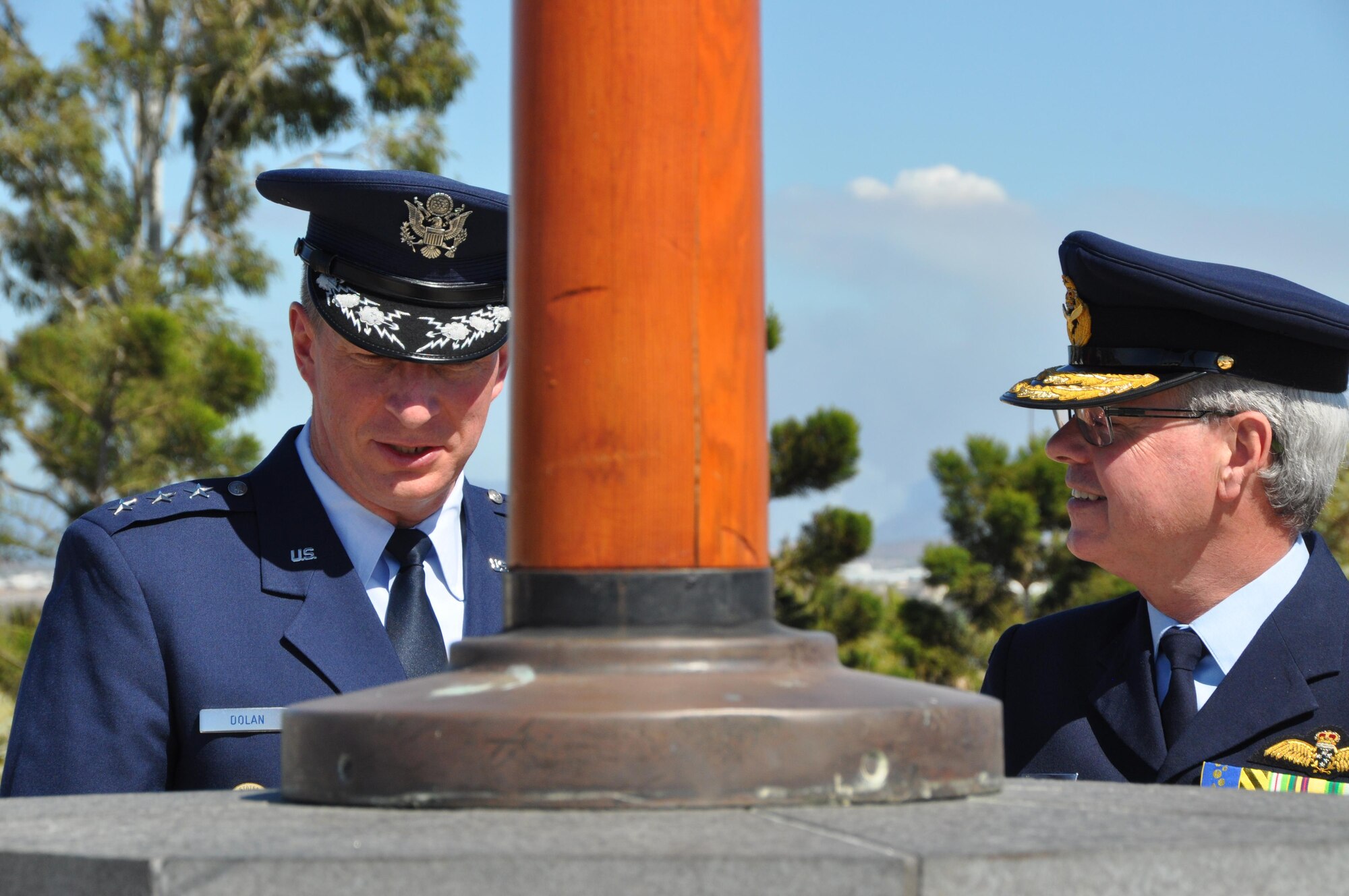 Lt. Gen. John Dolan, Commander, 5th Air Force, and Australian Air Vice-Marshal Kym Osley, Active Reserve Staff Group, discuss the sacrifices made by the men and women who served in 5th Air Force during World War II after the 5th Air Force Memorial Service held in Townsville, Australia Aug. 16, 2015. The 5th Air Force Memorial at Kissing Point, Townsville, Australia, was erected to honor and remember the men and women who gave their lives and to the many thousands who gave up their youth to serve their country in 5th Air Force during WW II. (U.S. Air Force photo by Capt. George M. Tobias/Released)
