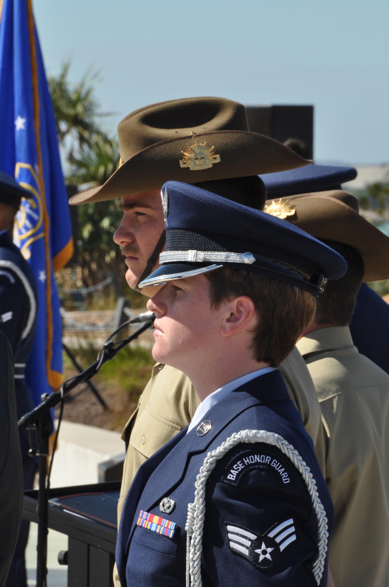 Senior Airman Megan Tubridy, 374th Civil Engineer Squadron and part of the Yokota Air Base Honor Guard, stands beside her Australian counter part during a 5th Air Force Memorial Service at Kissing Point, Townsville, Australia, Aug. 16, 2015. The memorial service honored the men and women who gave their lives and to the many thousands who gave up their youth to serve their country in 5th Air Force during World War II. (U.S. Air Force photo by Capt. George M. Tobias/Released)