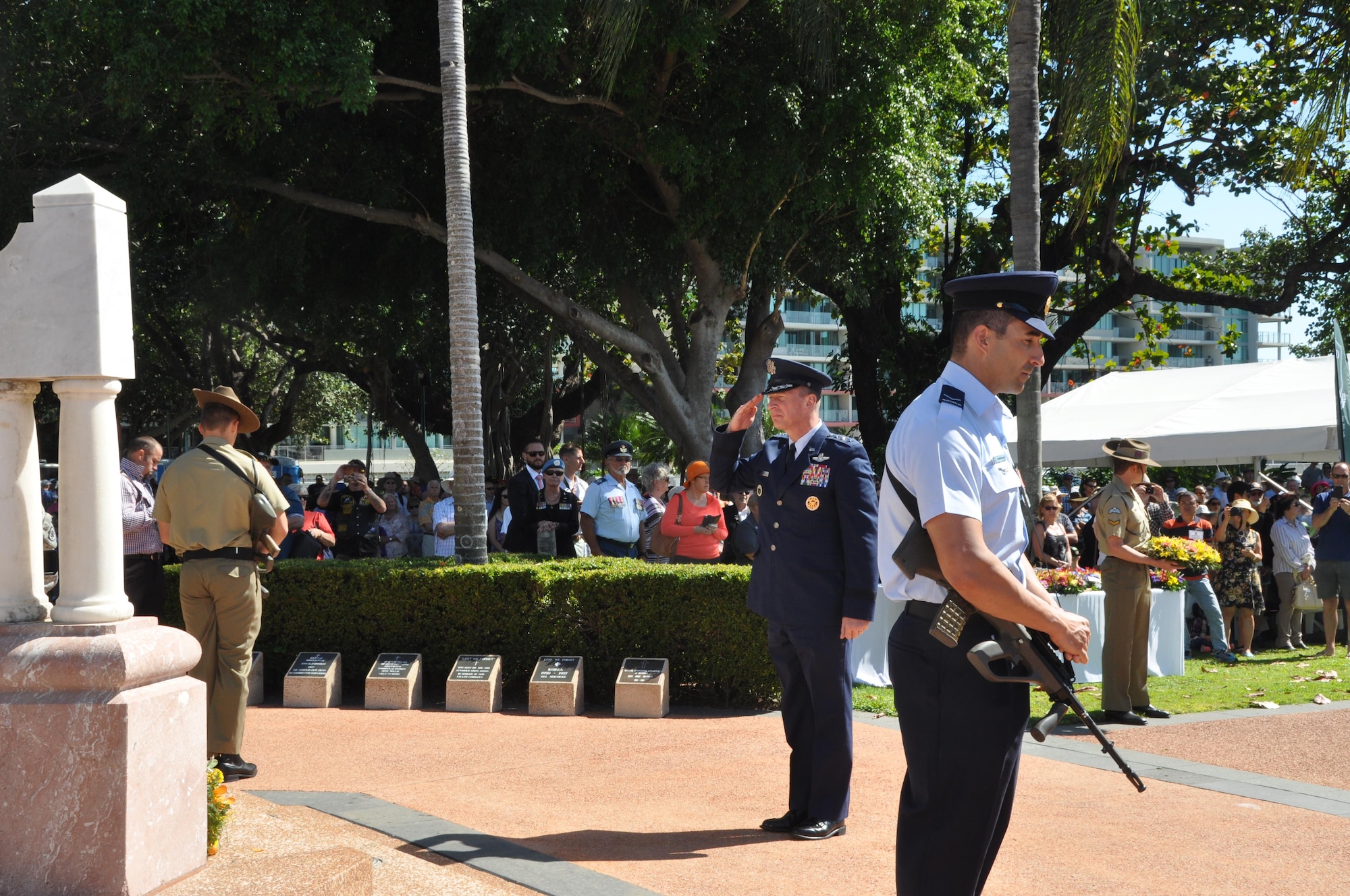 Lt. Gen. John Dolan, Commander, 5th Air Force, salutes after placing a wreath at the base of the War Memorial in ANZAC Park during the Townsville, Australia VP70 Memorial Service Aug 15, 2015. The service honored all those who gave their lives in the defense of their country and led to victory in the Pacific 70 years ago.  (U.S. Air Force photo by Capt. George M. Tobias/Released)