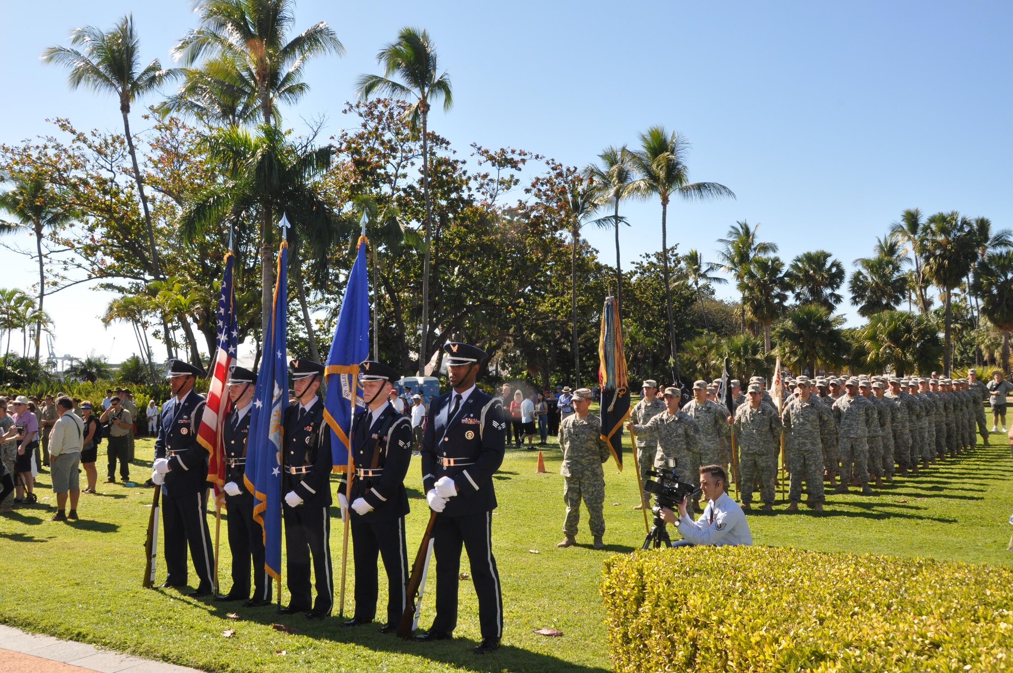 U.S. Airmen, part of the Yokota Air Base Honor Guard, and Soldiers, from the Hawaii-based 2nd Battalion, 27th Infantry Regiment, stand in formation during the Townsville, Australia VP70 Memorial Service, Aug. 15, 2015.  The service took place at ANZAC Park and honored all those who gave their lives in the defense of their country and led to victory in the Pacific 70 years ago. (U.S. Air Force photo by Capt. George M. Tobias/Released)
