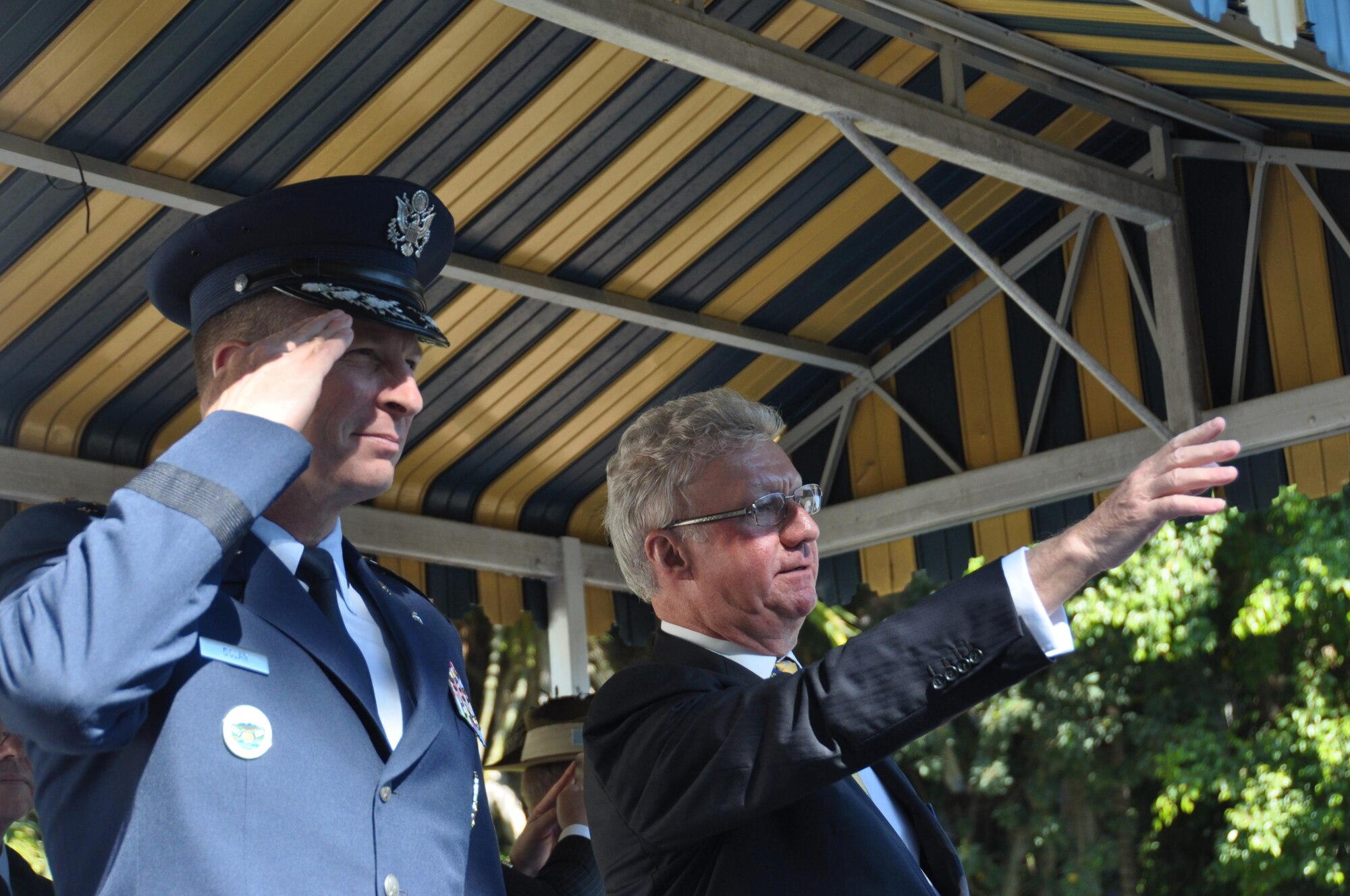 Lt. Gen. John Dolan, Commander, 5th Air Force, salutes as His Excellency the Honorable Paul de Jersey AC, Administrator of the Government of the Commonwealth of Australia, waves during a VP70 Parade, Aug. 15, 2015. The parade in honor veterans of World War II was part of several commemoration events marking the 70th anniversary of the end of WWII hosted by Townsville, Australia. (U.S. Air Force photo by Capt. George M. Tobias/Released)
