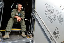 Master Sgt. Jason Staggs, 9th Airlift Squadron C-5M Super Galaxy loadmaster, acts as a safety observer from the crew entry door of the aircraft during engine start Aug. 11, 2015, at Dover Air Force Base, Del. From his vantage point Staggs is able to see problems those on the ground might not see and alert the cockpit crew immediately. (U.S. Air Force photo/Greg L. Davis) 