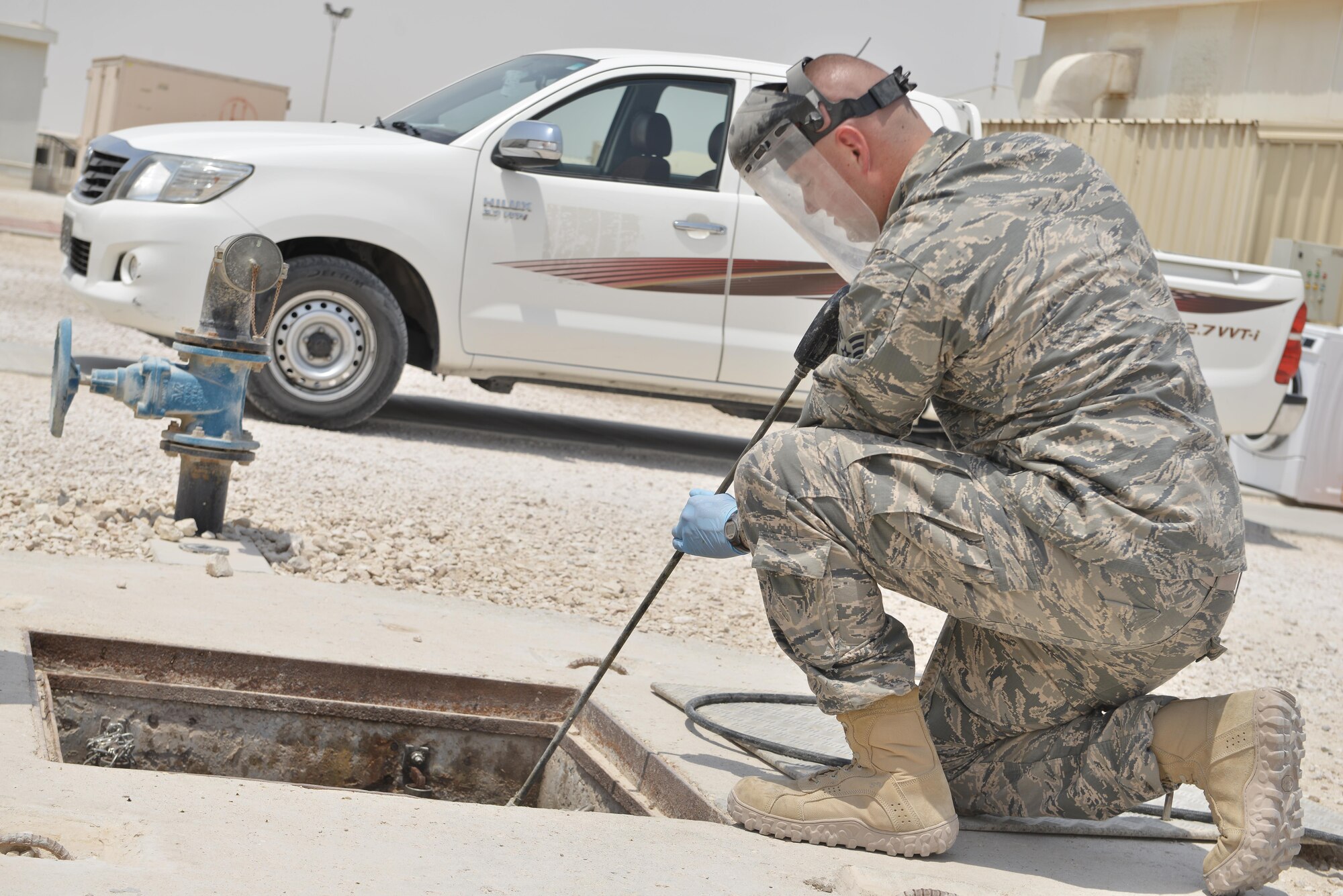 Airman 1st Class Joshua Rickerd, 379th Expeditionary Civil Engineer Squadron water and fuels, sprays down a lift station with water to keep bacteria and mold from backing up the plumbing system August 14, 2015 at Al Udeid Air Base, Qatar. Waste water is tested and monitored daily to ensure the systems are running smoothly and do not back up. With the high number of deployed members here at Al Udeid, the airmen stay busy day and night keeping the septic systems running to support the base. (U.S. Air Force photo/ Staff Sgt. Alexandre Montes