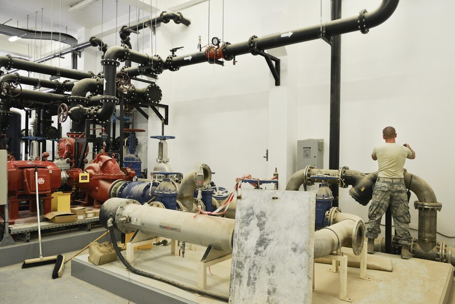 Airman 1st Class Steven Blakeley, 379th Expeditionary Civil Engineer Squadron water and fuels, opens a main valve that supplies water through a purifying system that is used for indoor plumbing throughout the Blatchford Preston Complex August 16, 2015 at Al Udeid Air Base, Qatar.  With the high number of deployed members here at Al Udeid, the 379th ECES water and fuels airmen stay busy day and night keeping the systems running to support the base. (U.S. Air Force photo/ Staff Sgt. Alexandre Montes)