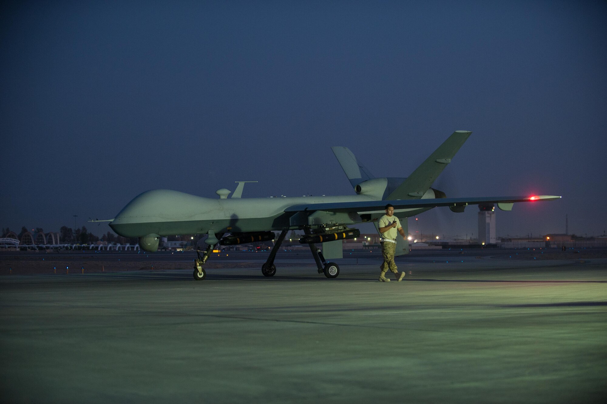 A U.S. Airman assigned to the 62nd Expeditionary Reconnaissance Squadron finishes a post flight inspection on a MQ-9 Reaper aircraft at Kandahar Airfield, Afghanistan, Aug. 13, 2015.  The 62nd ERS operates the MQ-1 Predator and Reaper aircraft and provides world-class close air support, intelligence, surveillance and reconnaissance capabilities in Afghanistan. (U.S. Air Force photo by Tech. Sgt. Joseph Swafford/Released) 
