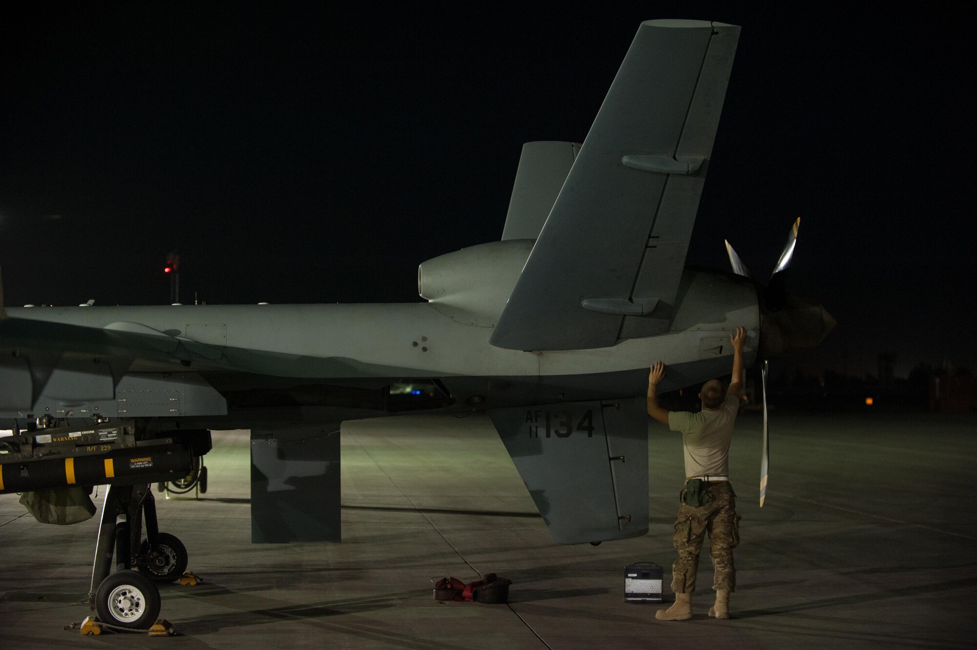 A U.S. Airman assigned to the 62nd Expeditionary Reconnaissance Squadron performs a post flight inspection on a MQ-9 Reaper aircraft at Kandahar Airfield, Afghanistan, Aug. 13, 2015.  The 62nd ERS operates the MQ-1B Predator and Reaper aircraft and provides world-class close air support, intelligence, surveillance and reconnaissance capabilities in Afghanistan. (U.S. Air Force photo by Tech. Sgt. Joseph Swafford/Released) 