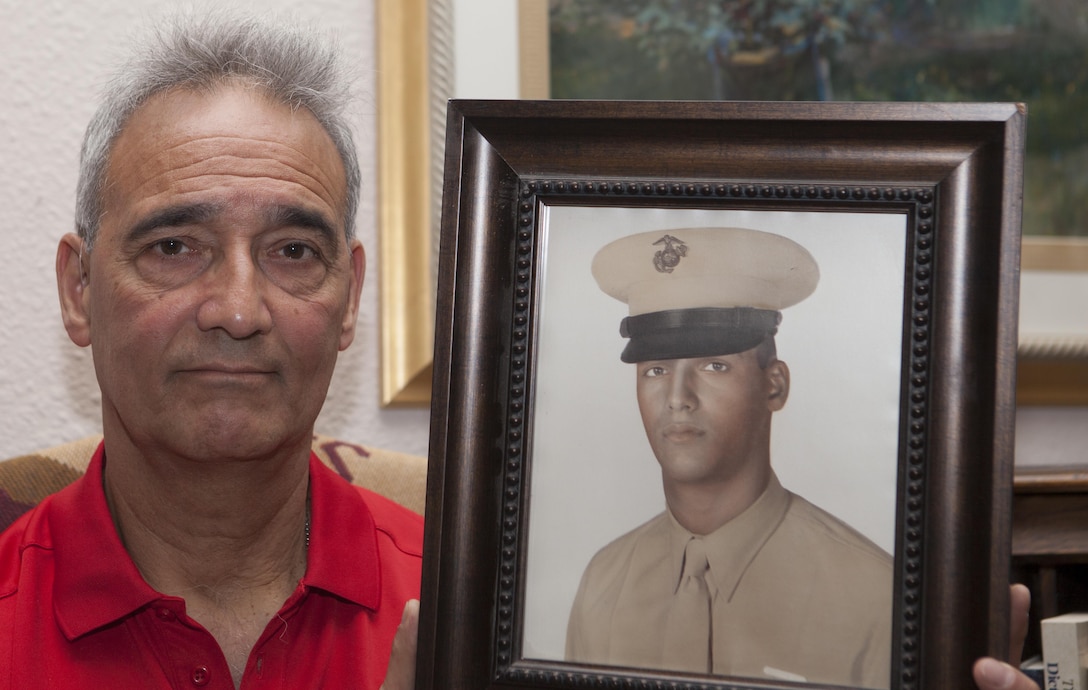 Benjamin "Ben" Palermo holds a photo of himself when he was serving on active duty in the Marine Corps at his home in San Antonio, Texas, June 4, 2015. Palermo served with H Company, 2nd Battalion, 4th Marine Regiment during Operation Starlite during August 1965 in Vietnam. 
