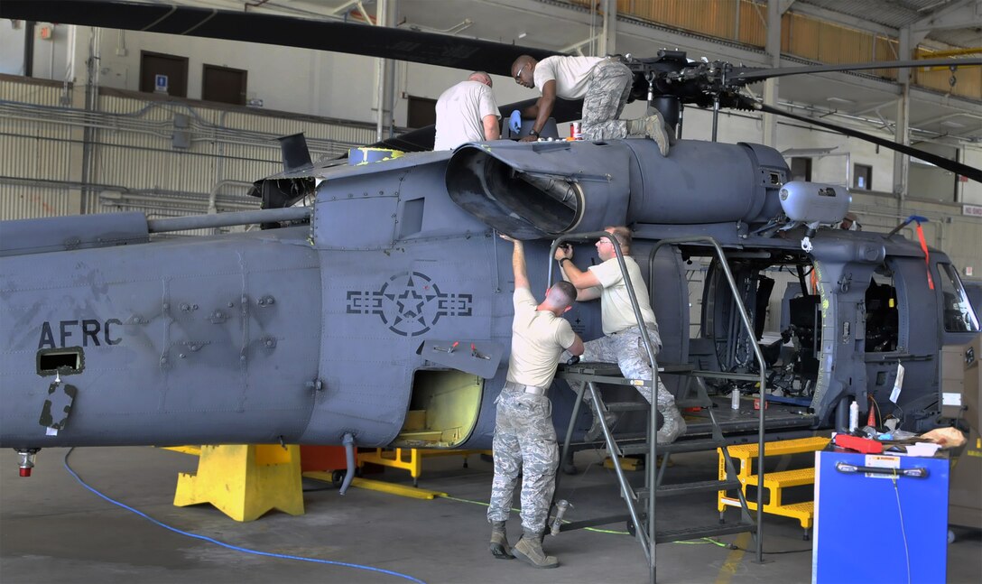 A crew of Reserve maintenance specialists from the 920th Rescue Wing work on one of the unit's HH-60G Pave Hawk helicopters. The wing is the Air Force Reserve's only combat rescue unit, and has recorded nearly 4,000 saves -- including more than 850 in combat. (U.S. Air Force photo/Master Sgt. Paul Flipse)