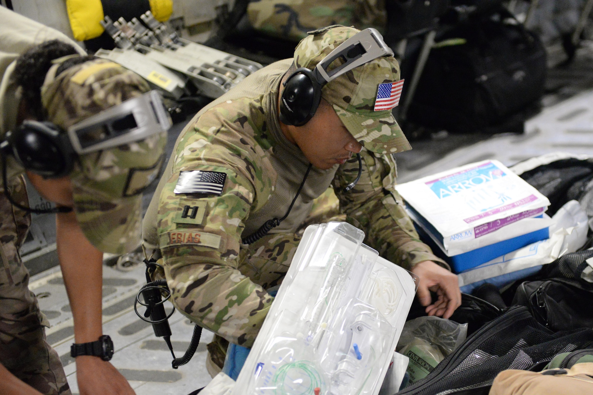 U.S. Air Force Capt. Jason Frias, 455th Expeditionary Aeromedical Evacuation Squadron Critical Care Air Transport Team critical care nurse deployed from the 60th Medical Group at Travis Air Force Base, California, checks in equipment bags for supplies during an aeromedical evacuation mission aboard a C-17 Globemaster III aircraft from Bagram Airfield, Afghanistan, to Ramstein Air Base, Germany, Aug. 9, 2015. The 455th EAES’ CCATT is a three-person, highly specialized medical team consisting of a physician who specializes in an area of critical care or emergency medicine, a critical care nurse and a respiratory therapist. The CCATT is charged with providing critical care to the sick and wounded as they are moved thousands of miles onboard U.S. cargo aircraft to receive full-time care elsewhere.  (U.S. Air Force photo by Maj. Tony Wickman/Released)