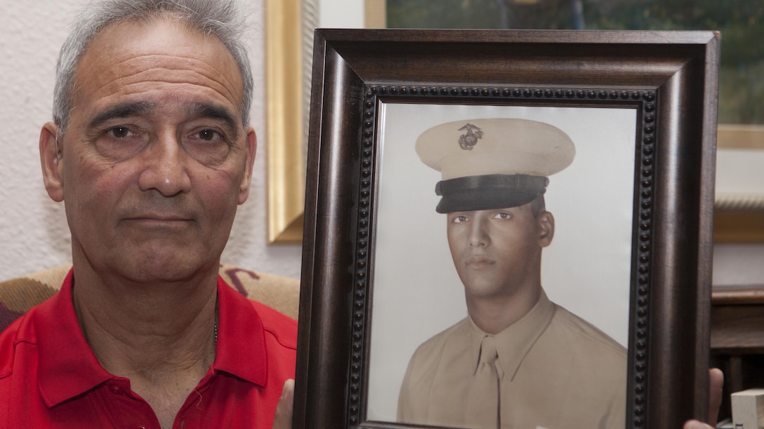 Benjamin "Ben" Palermo holds a photo of himself when he was serving on active duty in the Marine Corps in his home in San Antonio, Texas, June 4, 2015. Palermo served with G Company, 2nd Battalion, 4th Marine Regiment during Operation Starlite during August 1965 in Vietnam. 