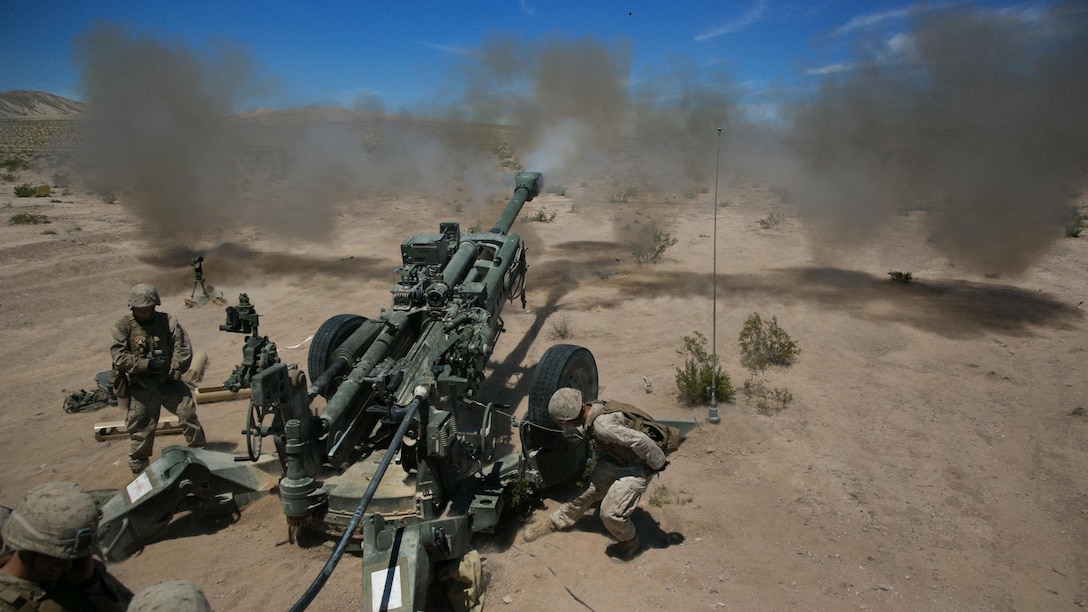 Marines with B battery, 1st Battalion, 10th Marine Regiment, provide support fire as part of Large Scale Exercise 15 in the vicinity of the Black Top Training Area, Aug. 15, 2015. The artillery fire supported a ground element during their assault on two objectives during the live-fire exercise. 