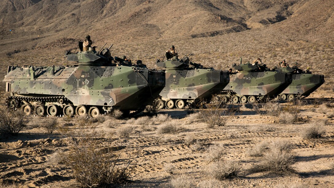 Amphibious Assault Vehicle operators with 1st Battalion, 3rd Marine Regiment, stage for a 50 kilometer, live-fire and maneuver exercise in support of Large Scale Exercise 15 in the vicinity of the Blacktop Training Area aboard the Combat Center, Aug. 15, 2015. The ground maneuver element was tasked with assaulting two objectives with support from artillery, mortars, tanks and close-air support. 