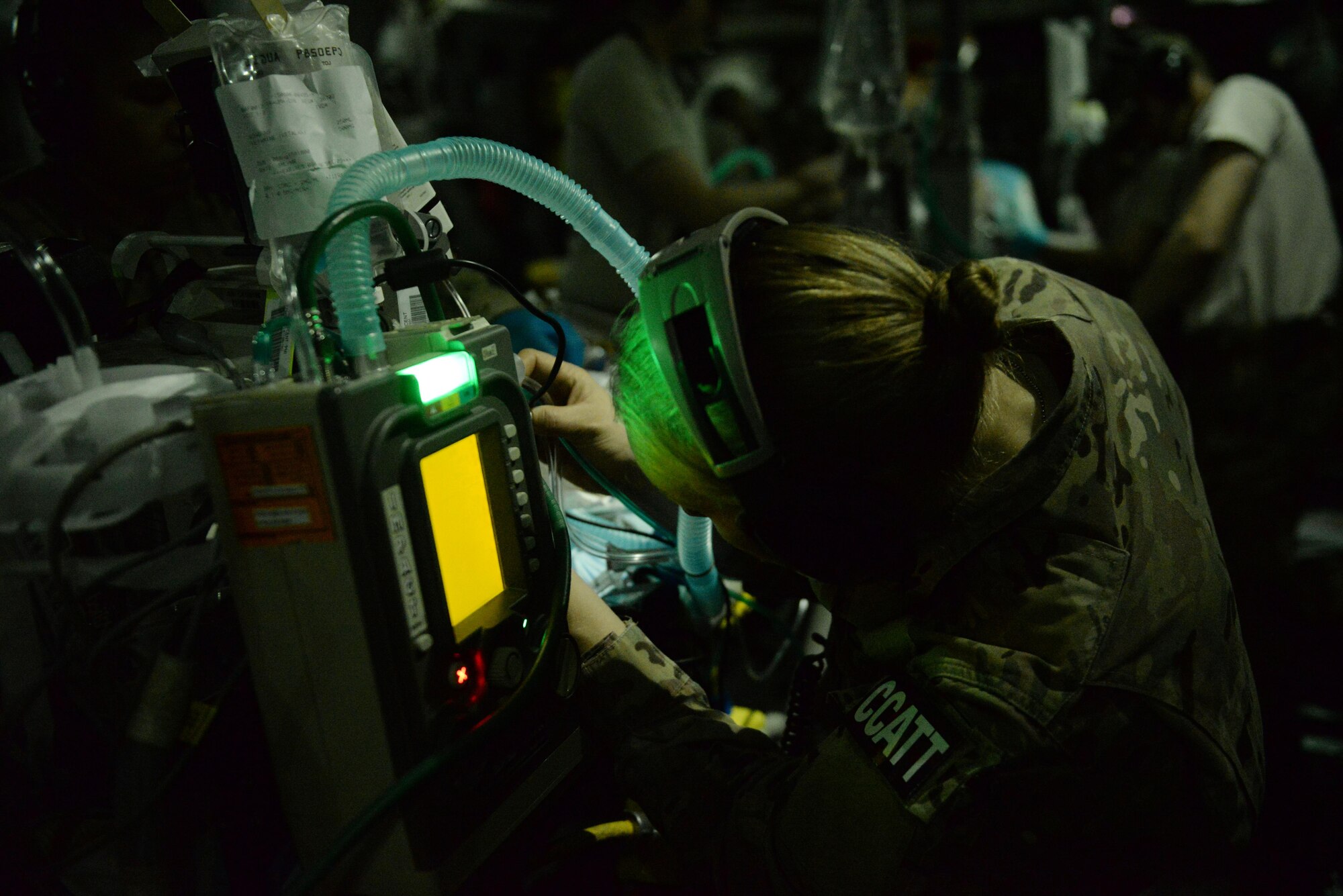 U.S. Air Force Capt. Deann Hoelscher, 455th Expeditionary Aeromedical Evacuation Squadron Critical Care Air Transport Team physician deployed from the 60th Medical Group at Travis Air Force Base, California, checks on a patient’s status during an aeromedical evacuation mission aboard a C-17 Globemaster III aircraft from Bagram Airfield, Afghanistan, to Ramstein Air Base, Germany, Aug. 9, 2015. The 455th EAES’ CCATT is a three-person, highly specialized medical team consisting of a physician who specializes in an area of critical care or emergency medicine, a critical care nurse and a respiratory therapist. The CCATT is charged with providing critical care to the sick and wounded as they are moved thousands of miles onboard U.S. cargo aircraft to receive full-time care elsewhere.  (U.S. Air Force photo by Maj. Tony Wickman/Released)