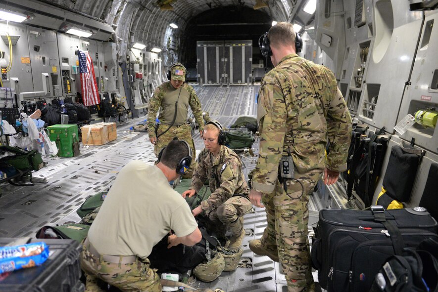 U.S. Airmen assigned to the 455th Expeditionary Aeromedical Evacuation Squadron repack AE equipment and supplies after an AE mission aboard a C-17 Globemaster III aircraft at Ramstein Air Base, Germany, Aug. 9, 2015. The 455th EAES Airmen are charged with the responsibility of evacuating the sick and wounded from Central Command to higher echelons of medical care. (U.S. Air Force photo by Maj. Tony Wickman/Released) 