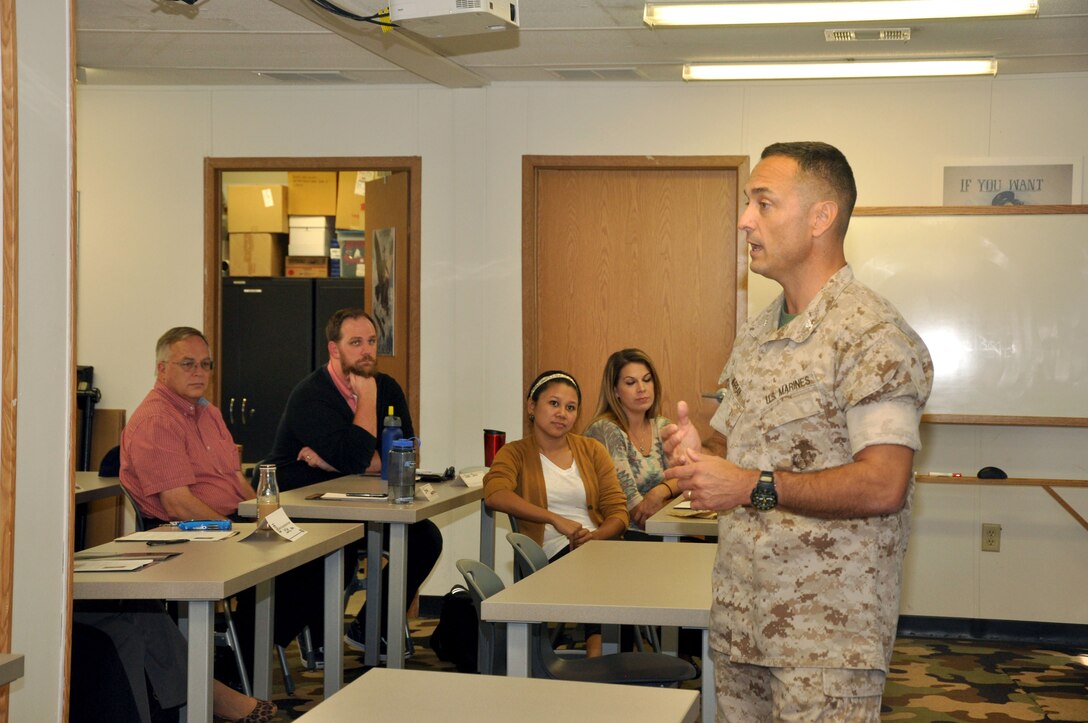 Base Commander Col. Joseph Murray addresses Civilian Marines on the second day of the Marine Corps Acculturation Program at the National Museum of the Marine Corps, Aug. 13. The program was created to help civilians transition into their careers as government employees and provide a historical seminar about the Marines they support. Instruction for the course was provided by Sgt. Maj. (Ret.) Jamie Deets and Gunnery Sgt. (Ret.) Nathan Taylor.