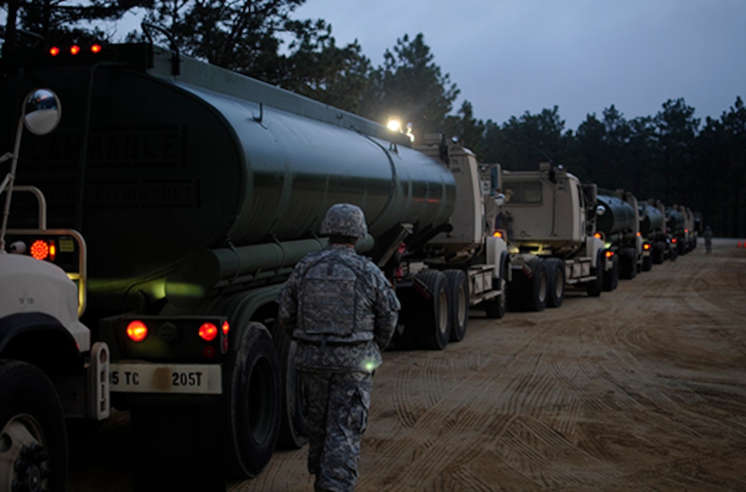 Staff Sgt. James Hardin, a motor transport operator with the Army Reserve’s 705th Transportation Company, inspects vehicle placards prior to the departure of a petroleum supply convoy June 12 during the Quartermaster Liquid Logistics Exercise at Fort Bragg, North Carolina. QLLEX is an annual logistical movement event in which service members transport petroleum and purified water throughout the U.S. 