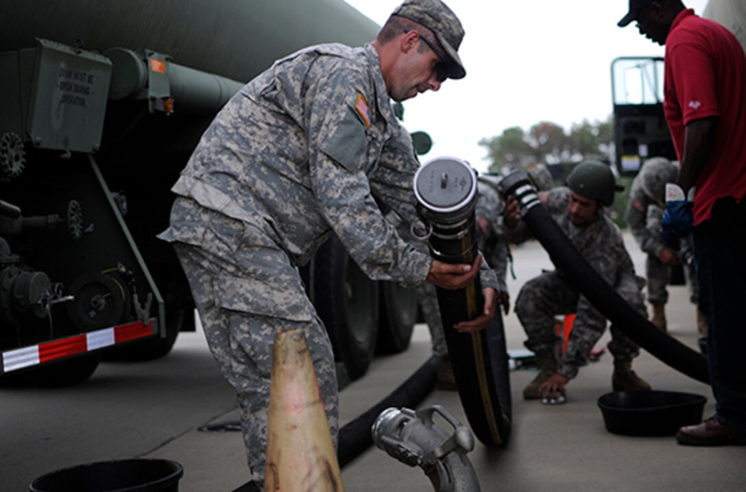 A motor transport operator with the Army Reserve’s 705th Transportation Company prepares to offload his fuel carrier June 12 during the Quartermaster Liquid Logistics Exercise at Fort Bragg, North Carolina. QLLEX is an annual logistical movement event in which service members transport petroleum and purified water throughout the U.S. 