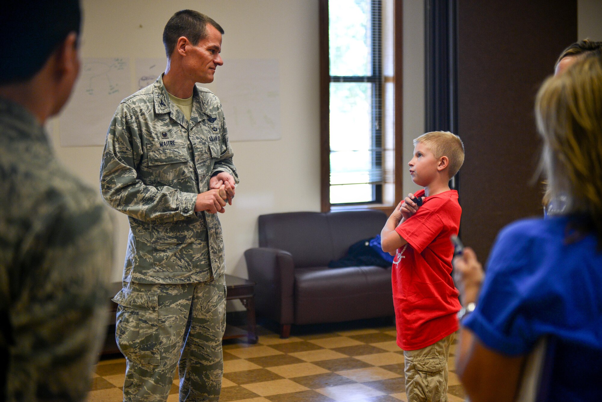 A young Air Commando asks U.S. Air Force Col. Ben Maitre, 27th Special Operations Wing commander, a question about life at Cannon during the Student Connections Round-Up Aug. 13, 2015 at Cannon Air Force Base, N.M. The Round-Up was designed to improve quality of life for Cannon kids, creating an environment where they could learn new skills and make new friends before their first day of school. (U.S. Air Force photo/Airman 1st Class Shelby Kay-Fantozzi)