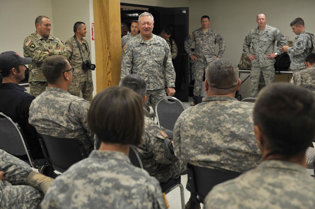 Army Gen. Frank Grass, center, U.S. National Guard Bureau chief, talks to aviation troops at Redding Municipal Airport in Northern Calif., Aug. 19, 2015. 