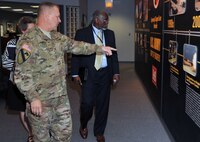 Col. Robert Ruch, U.S. Army Engineering and Support Center, Huntsville commander, provides Tommy Marks, Army Office of Small Business Program director, with look at Huntsville Center’s history over the years while passing by the Center’s history timeline wall Aug. 19. After meeting with Huntsville Center leadership, Marks received a command overview briefing followed by an acquisition overview briefing before meeting with the Huntsville Center Small Business Office staff.