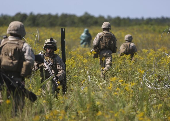 Marines with Alpha Company, 2nd Combat Engineer Battalion, advance toward the enemy position during a platoon fire and maneuver range at Fort A.P. Hill, Va., Aug. 13, 2015. The platoons put everything they had learned so far during the deployment for training exercise to the test by using both their provisional infantry and combat engineering skills during the culminating event. (U.S. Marine Corps photo by Cpl. Michelle Reif/Released)