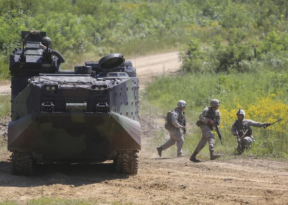 Marines with Alpha Company, 2nd Combat Engineer Battalion, dash out of an assault amphibious vehicle during a platoon fire and maneuver range at Fort A.P. Hill, Va., Aug. 13, 2015. The platoons put everything they had learned so far during the deployment for training exercise to the test by using both their provisional infantry and combat engineering skills during the culminating event. (U.S. Marine Corps photo by Cpl. Michelle Reif/Released)