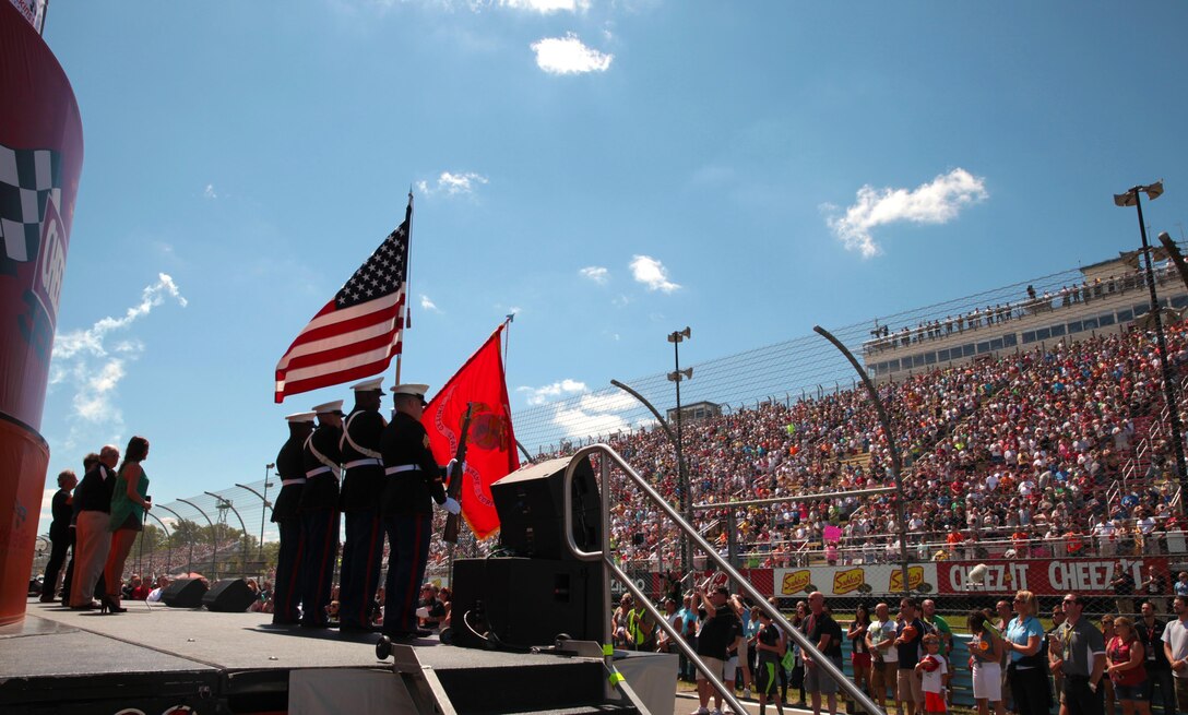 A U.S. Marine Corps Color Guard participates in the opening ceremony of the Cheez-It 355 NASCAR Sprint Cup at Watkins Glen International, Aug. 9. The Marines, from Recruiting Station Buffalo, also conducted a swearing-in ceremony for 14 poolees and drove an H1 Humvee on the track as part of the race day festivities. (Official U.S. Marine Corps photo by Sgt. Christopher O’Quin/Released)