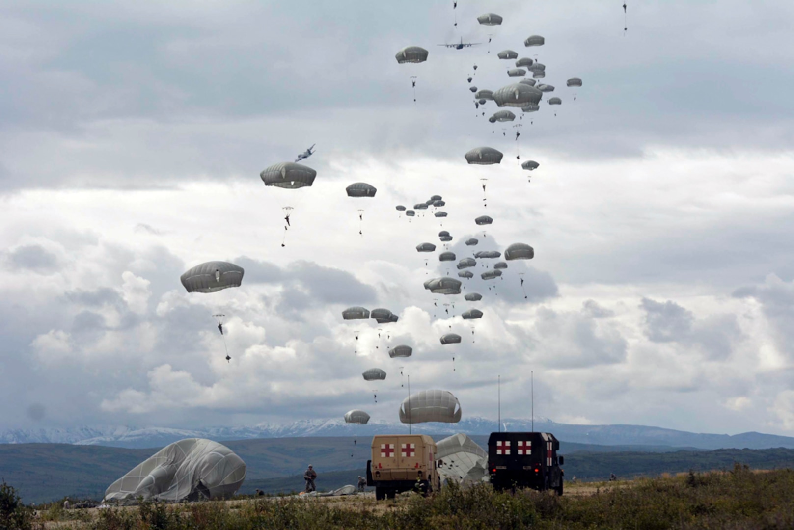 In this photo, Japan Ground Self-Defense Forces from the 1st Airborne Brigade and 4th Brigade (Airborne), 25th Infantry Division paratroopers perform an airborne insertion and airfield seizure at Fort Greely, Alaska, Aug. 12. This event was part of Exercise Arctic Aurora 2015. 