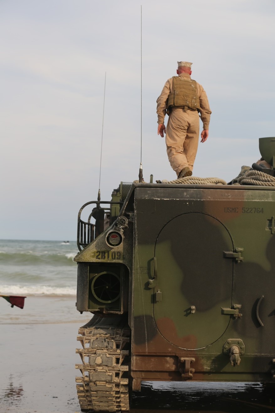 A Marine with 1st Platoon, Bravo Company, 2nd Assault Amphibian Battalion performs the final check on an amphibious assault vehicle before giving it the all clear to push into the surf on Onslow Beach aboard Camp Lejeune, N.C.  Aug. 17, 2015. Doing a double check of the AAVs is paramount for safety in making sure everything is in working order. (U.S. Marine Corps photo by Pfc. Miranda Faughn/Released)