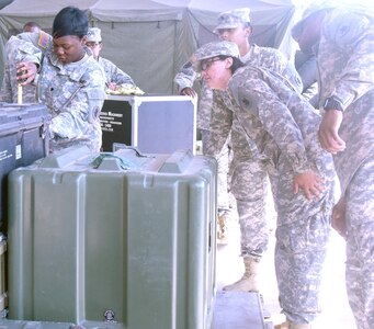 During 463L pallet building and loading training at Fort Sam  Houston July 23, U.S. Army South Soldiers measure the height of the cargo they created in order to determine which type of netting is necessary to strap the cargo down to the 463L pallet.