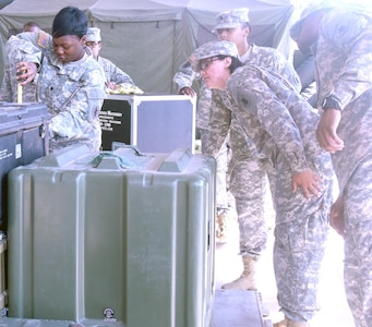 During 463L pallet building and loading training at Fort Sam  Houston July 23, U.S. Army South Soldiers measure the height of the cargo they created in order to determine which type of netting is necessary to strap the cargo down to the 463L pallet.