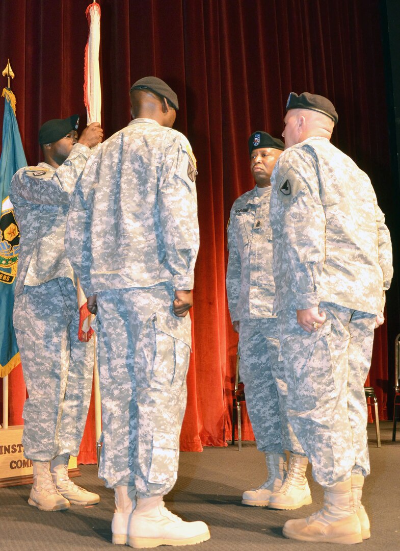 Col. Tim Strange (right) officiates a change of responsibility from Command Sgt. Maj. Jesse Hammond Jr. (second from right) to Command Sgt. Maj. Jerry Charles (second from left) during a ceremony at Fort Sam Houston Aug. 13. Strange is the 412th  Contracting Support Brigade commander.