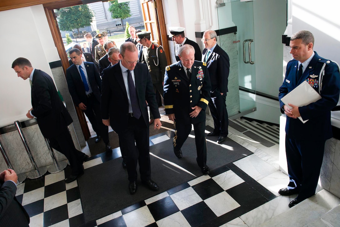 U.S. Army Gen. Martin E. Dempsey, center right, chairman of the Joint Chiefs of Staff, walks with Irish Defense Minister Simon Coveney at Ireland's Defense Ministry in Dublin, Aug. 18, 2015. DoD photo by D. Myles Cullen