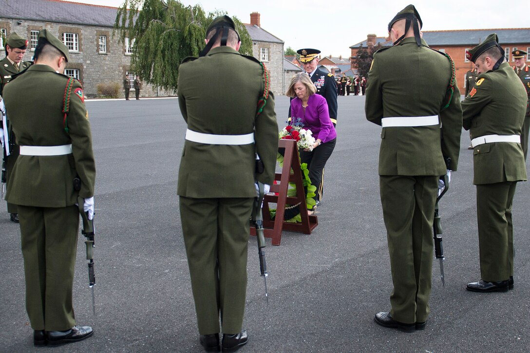 Deanie Dempsey,center, wife of U.S. Army Gen. Martin E. Dempsey,  chairman of the Joint Chiefs of Staff, presents flowers during ceremony to honor the Irish military veterans at Cathal Brugha Barracks in Dublin, Aug. 18, 2015. DoD photo by D. Myles Cullen