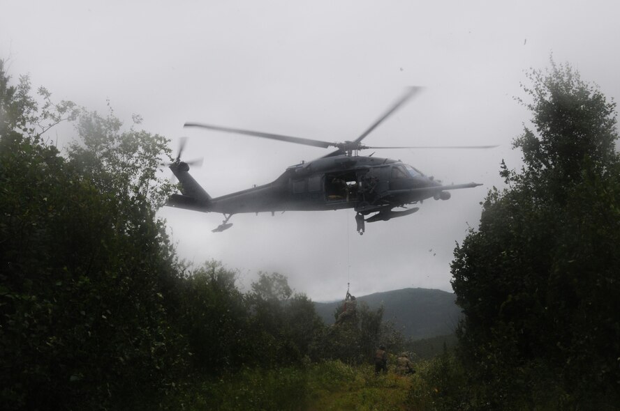 U.S. Air Force Airmen from the Alaska National Guard's 210th and 212th Rescue Squadrons rescue a pilot during an isolated personnel recovery exercise Aug. 13, 2015, at Eielson Air Force Base, Alaska, as part of RED FLAG-Alaska (RF-A) 15-3.  RF-A is a Pacific Air Forces commander-directed field training exercise for U.S. and partner nation forces, providing combined offensive counter-air, interdiction, close air support and large force employment training in a simulated combat environment.  (U.S. Air Force photo by Master Sgt. Ralph Kapustka/Released)