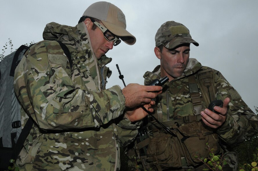 U.S. Air Force Staff Sgt. Tyler Boyer and Airman 1st Class Matt O'Brien, both specialists with the Alaska Air National Guard's 212th Rescue Squadron, confirm latitude and longitude coordinates during a downed pilot exercise at Eielson Air Force Base, Alaska, Aug. 12, 2015, while participating in RED FLAG-Alaska 15-3.  RF-A is a Pacific Air Forces commander-directed field training exercise for U.S. and partner nation forces, providing combined offensive counter-air, interdiction, close air support and large force employment training in a simulated combat environment.  (U.S. Air Force photo by Master Sgt. Ralph Kapustka/Released)