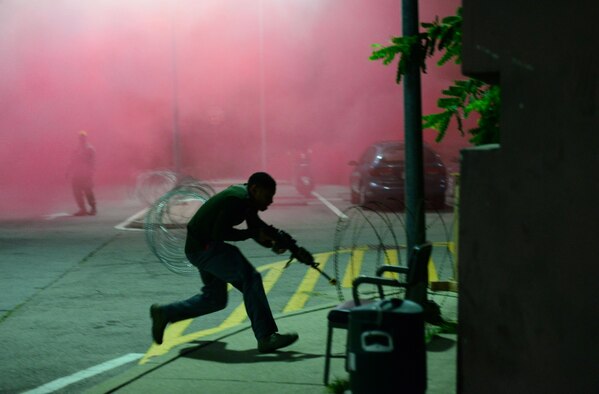 Opposing Forces simulate an attack on a defensive fighting position manned by 51st Fighter Wing Security Forces airmen during exercise Beverly Midnight 15-03 at Osan Air Base, Republic of Korea, August 20, 2015.   During this exercise, wing capabilities such as defending against simulated ground and aerial attacks and rapid-runway repair operations were tested (U.S. Air Force photo by Staff Sgt. Amber Grimm/Released)