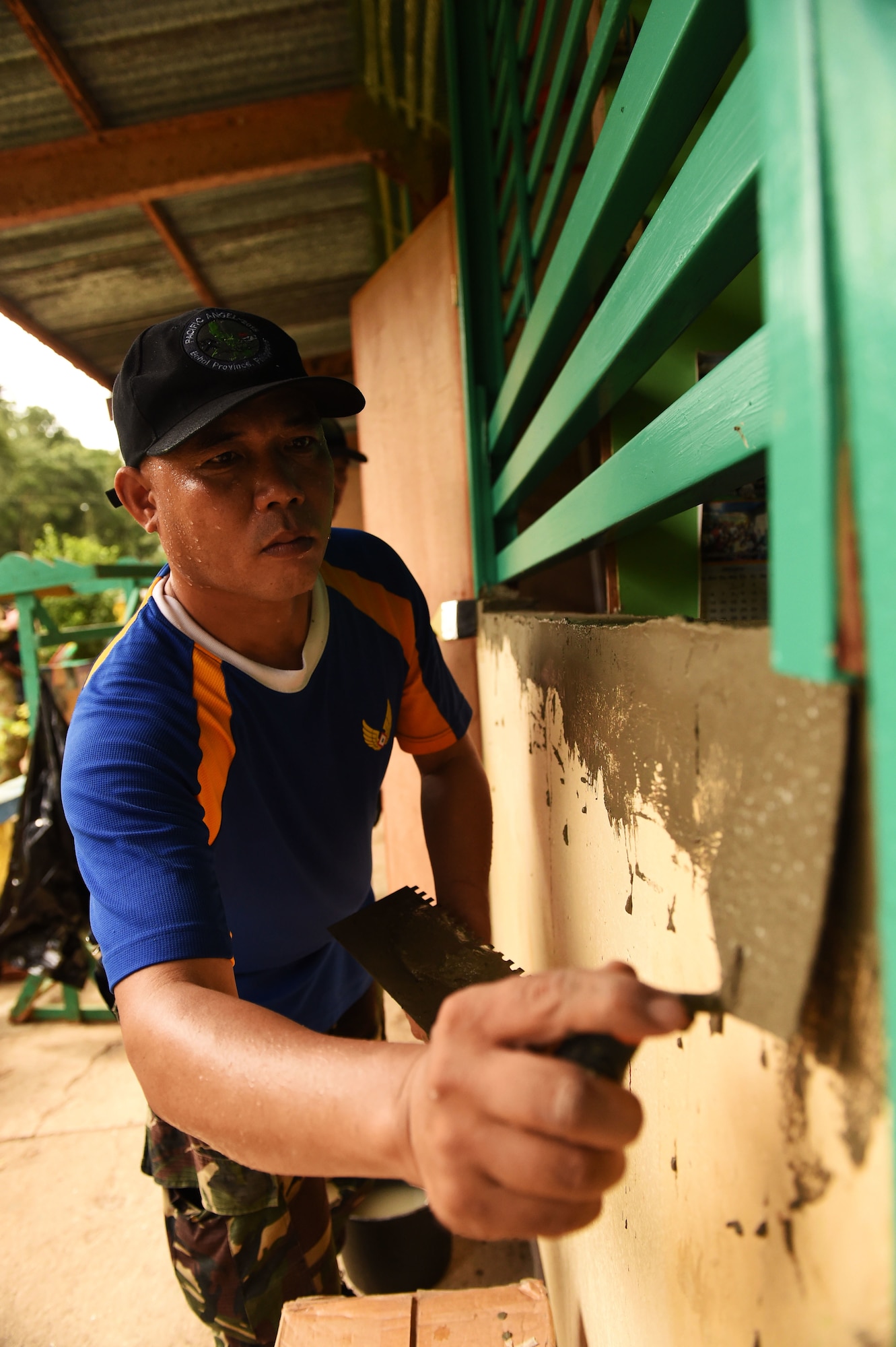 A member of the Armed Forces of the Philippines repairs the exterior wall of Owac Elementary school during Pacific Angel Philippines, Bohol Provence, Philippines, Aug. 19, 2015. Owac Elementary is one of six schools repaired by the U.S. Air Force, U.S. Army and U.S. Marine Corps along with service members from the Philippines and Australia. Efforts undertaken during Pacific Angel help multilateral militaries in the Pacific improve and build relationships across a wide spectrum of civic operations, which bolsters each nation’s capacity to respond and support future humanitarian assistance and disaster relief operations. (U.S. Air Force photo by Tech. Sgt. Aaron Oelrich/Released)