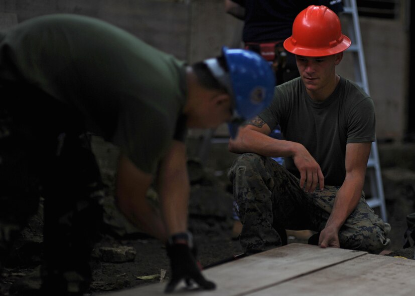 Marine Corps Lance Cpl. Aaron Marley, a carpenter with the 7th Engineer Support Battalion, Camp Pendleton, Calif., assists a member of the armed forces of the Philippines throughout the repairs made to Bartolome Doria Elementary School during Pacific Angel Philippines, Bohol Provence, Philippines, Aug. 15, 2015. This was one of six schools repaired by the Air Force, Army and Marine Corps, along with service members from the Philippines and Australia. (U.S. Air Force photo/Tech. Sgt. Aaron Oelrich) 