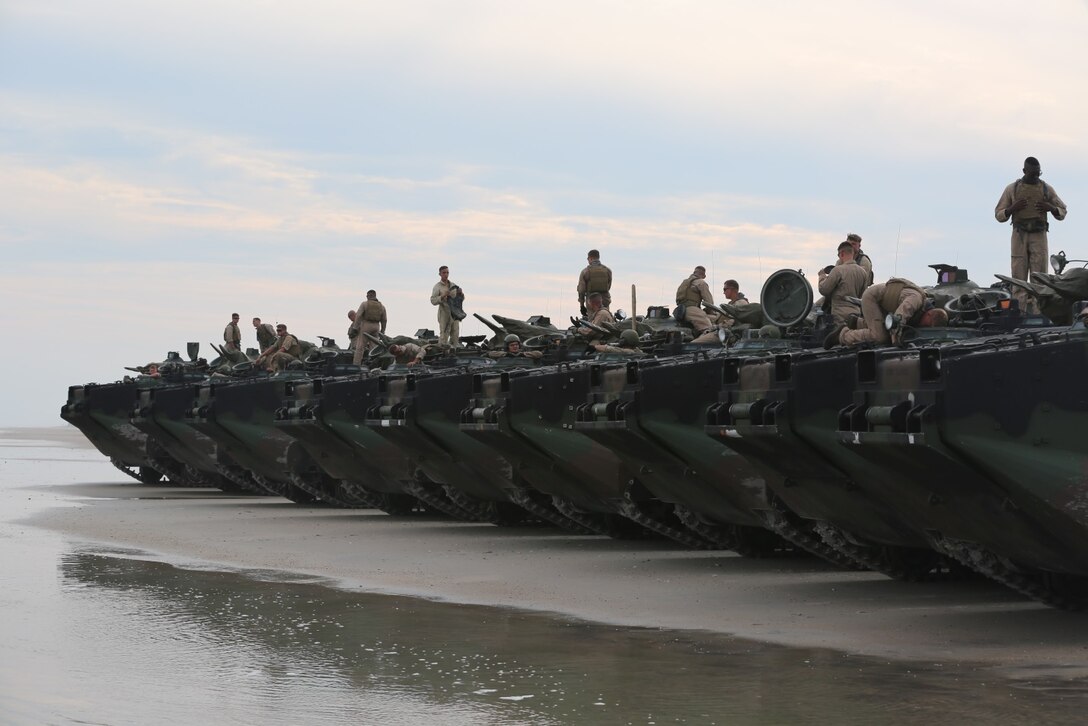 Marines with 1st Platoon, Bravo Company, 2nd Assault Amphibian Battalion wait for the final check of their amphibious assault vehicles and then go ahead to conduct their training exercise on Onslow Beach aboard Camp Lejeune N.C. Aug. 17, 2015. Doing a double check of the AAVs is paramount for safety in making sure everything is in working order.