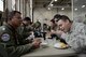 U.S. Air Force Senior Airman Kenny Batallas, 374th Operations Support Squadron aircraft flight equipment technician, samples authentic Thai food with the Royal Thai Air Force during Red Flag-Alaska at Joint Base Elmendorf-Richardson, Alaska, Aug. 18, 2015. Members of the RTAF invited Batallas to share meals often during the 10-day exercise, to build relationships, exchange stories and allow the Airmen to sample a variety of authentic Thai food. (U.S. Air Force photo by Staff Sgt. Cody H. Ramirez/Released)