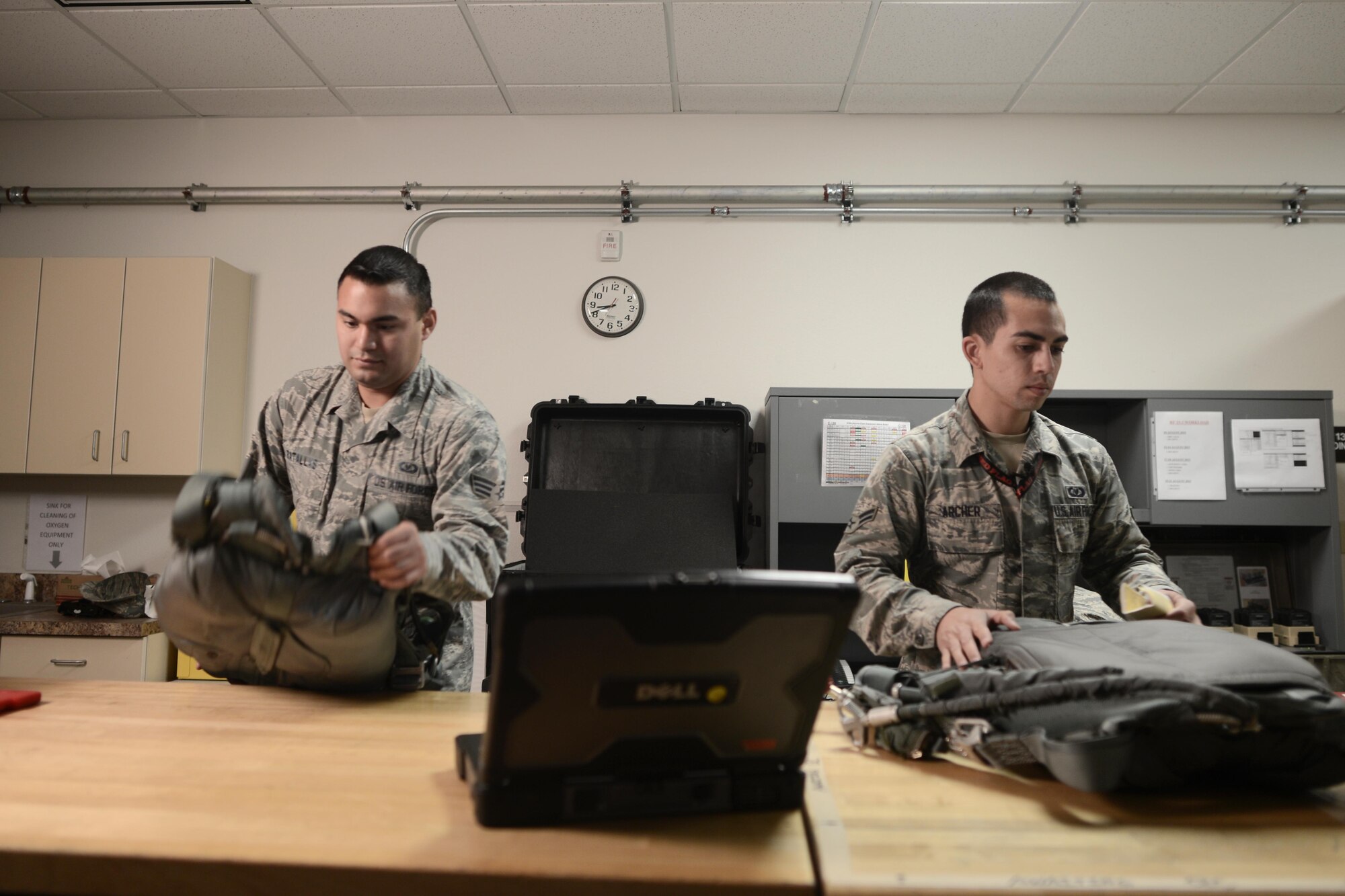 Senior Airman Kenny Batallas and Airman 1st Class Jonathon Archer, both aircrew flight equipment technicians with the 374th Operations Support Squadron, inspect parachutes for wear and tear during Red Flag-Alaska at Joint Base Elmendorf-Richardson, Alaska, Aug. 18, 2015. The AFE members joined the 36th Airlift Squadron during Red Flag-Alaska, servicing the aircrew safety equipment such as harnesses, helmets, masks and parachutes. (U.S. Air Force photo by Staff Sgt. Cody H. Ramirez/Released)