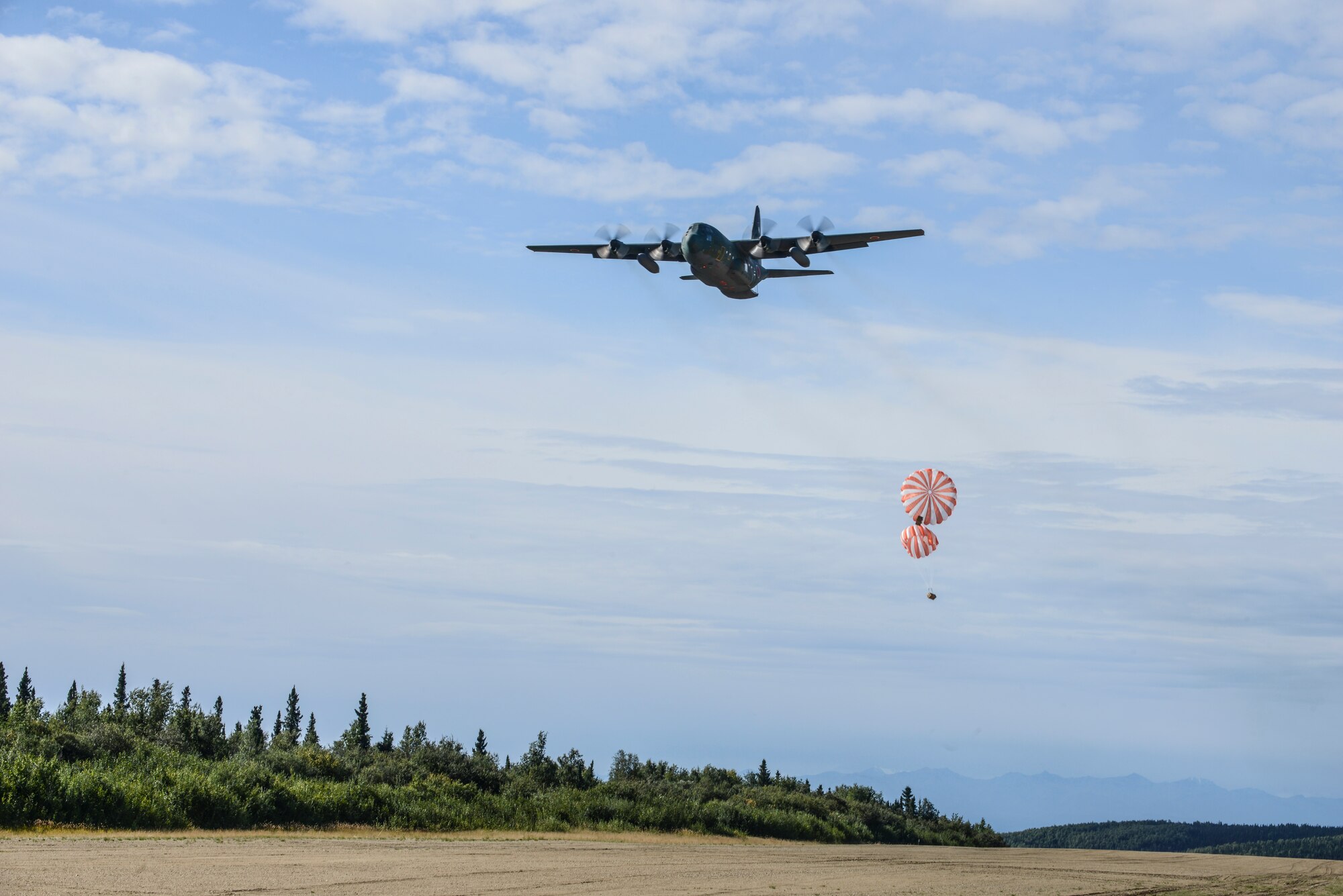 A Japan Air Self-Defense Force C-130 Hercules performs an air drop demonstration Aug. 17, 2015, during RED FLAG-Alaska (RF-A) 15-3 at the Joint Pacific Alaska Range Complex. The demonstration was for the Executive Observer Program, which is designed to present Pacific Air Force’s premier multinational large force employment exercise while building partnerships with senior airpower leaders from the global community. (U.S. Air Force photo by Senior Airman Ashley Nicole Taylor/Released)