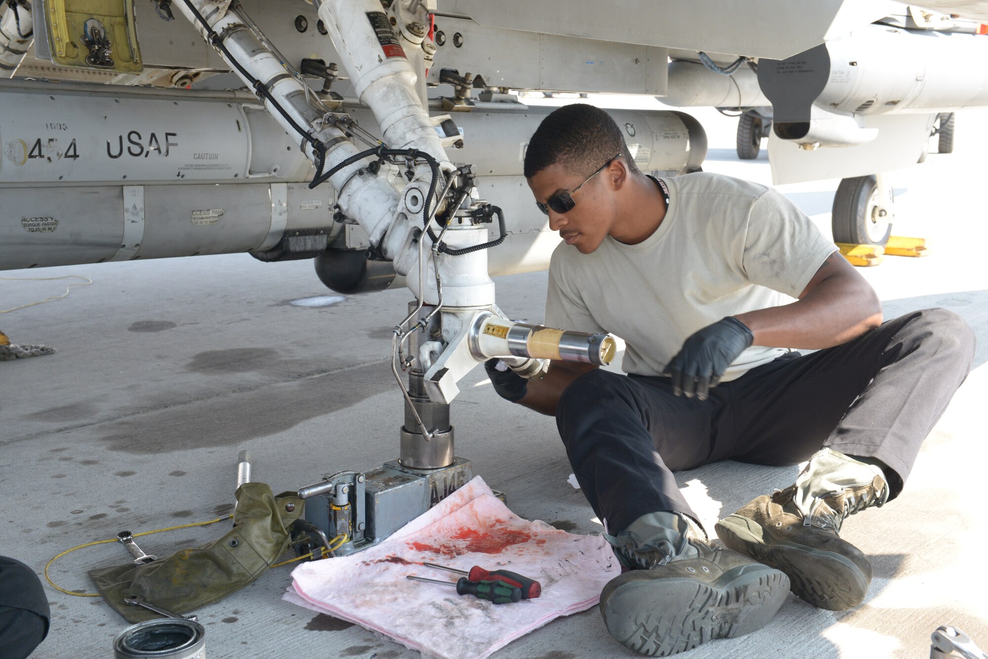 Senior Airman Jordan Cotton, a maintainer assigned to the 20th Aircraft Maintanence Squadron,  Shaw Air Force Base, S.C., work on an F-16 Fighting Falcon during Red Flag 15-4 at Nellis AFB, Nev., Aug. 19, 2015. Red Flag gives aircrew and air support operations service members from various airframes, military services and allied countries an opportunity to integrate and practice combat operations. (U.S. Air Force photo by Airman 1st Class Rachel Loftis)