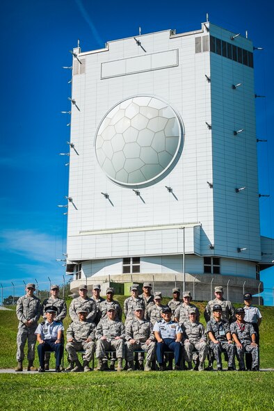 U.S. Air Force Airmen of Kadena Air Base’s 623d Air Control Flight and Japan Air Self Defense Force members from the 56th Aircraft and Warning Control Group pose in front of JASDF’s FPS-5 “Gamera” Radar on Okinawa, July 23, 2015. The 623d ACF traded stories of their common history with the 56th ACW while exploring JASDF’s Yozadake Sub Base. (Courtesy photo)