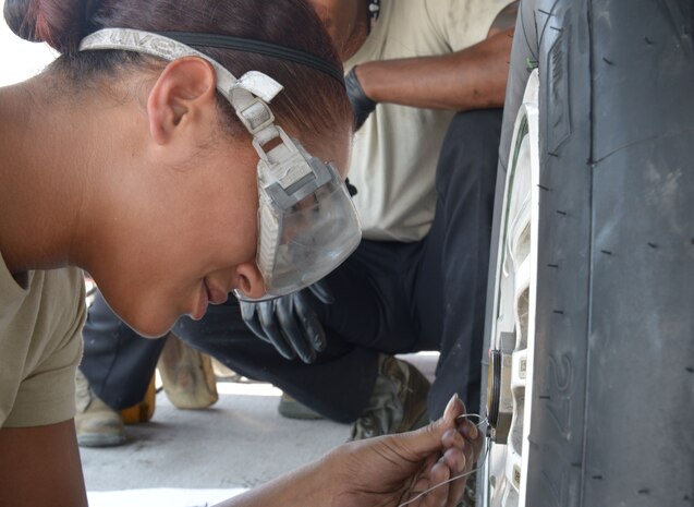 Staff Sgt. Ashley Grugin, a maintainer assigned to the 20th Aircraft Maintanence Squadron, Shaw Air Force Base, S.C., changes a landing gear tire on an F-16 Fighting Falcon during Red Flag 15-4 at Nellis Air Force Base, Nev., Aug. 19, 2015. Maintainers are responsible for and dedicated to overseeing the day-to-day maintenance of aircraft. (U.S. Air Force photo by Airman 1st Class Mikaley Towle)