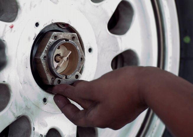 Staff Sgt. Ashley Grugin, a maintainer assigned to the 20th Aircraft Maintanence Squadron, Shaw Air Force Base, S.C., works on changing a landing gear tire on an F-16 Fighting Falcon during Red Flag 15-4 at Nellis AFB, Nev., Aug. 19, 2015. Red Flag provides a series of intense air-to-air scenarios for aircrew and ground personnel to increase their combat readiness and effectiveness for future real-world operations.  (U.S. Air Force photo by Airman 1st Class Rachel Loftis)