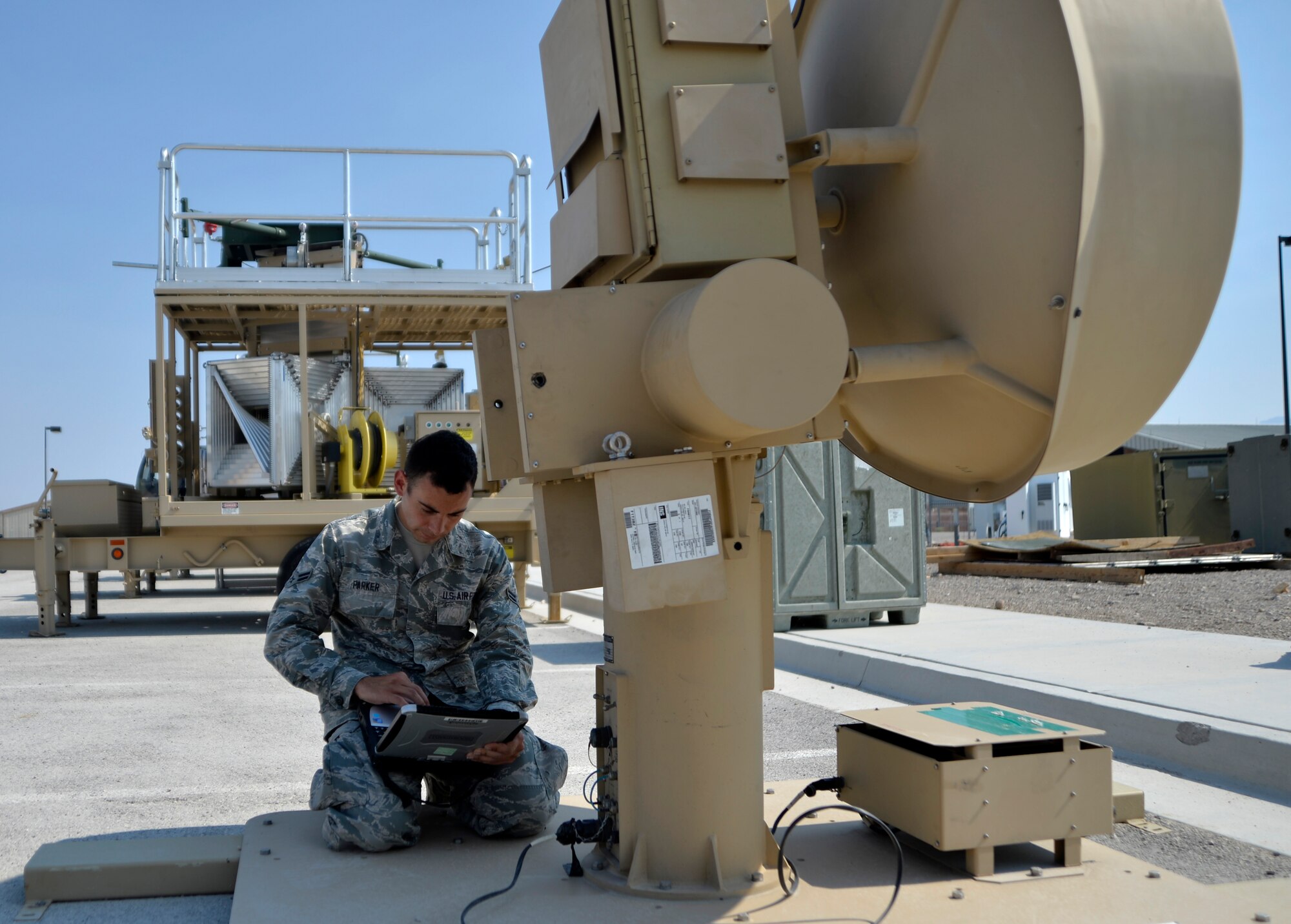 Airman 1st Class Stephen Parker, 432nd Aircraft Communications Maintenance Squadron ground control station maintainer, powers a ground data terminal used to transmit signals needed to fly both the MQ-1 Predator and MQ-9 Reaper remotely piloted aircraft Aug. 19, 2015, at Creech Air Force Base, Nevada. The GDT is responsible for providing the line-of-sight flying capabilities of an RPA. (U.S. Air Force photo by Airman 1st Class Christian Clausen/Released)
