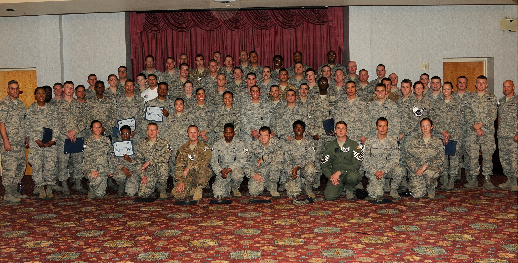 Col. Stephen Kravitsky, 90th Missile Wing commander, and Chief Master Sgt. Samuel Couch, 90th MW command chief, pose for a photo with staff sergeant selects from 20th Air Force and the 90th MW in the Trail’s End Event Center on F.E. Warren Air Force Base, Wyo., Aug. 20, 2015. Selects receive a line number that dictates when they will “sew on,” or officially become a staff sergeant. (U.S. Air Force photo by Senior Airman Jason Wiese)